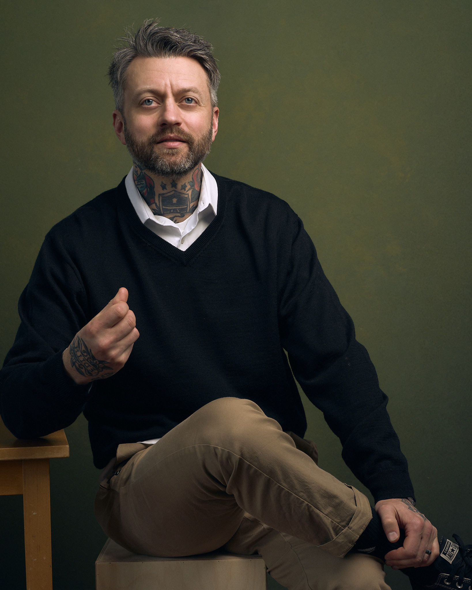 book page: portrait of man with tattoos, green background
